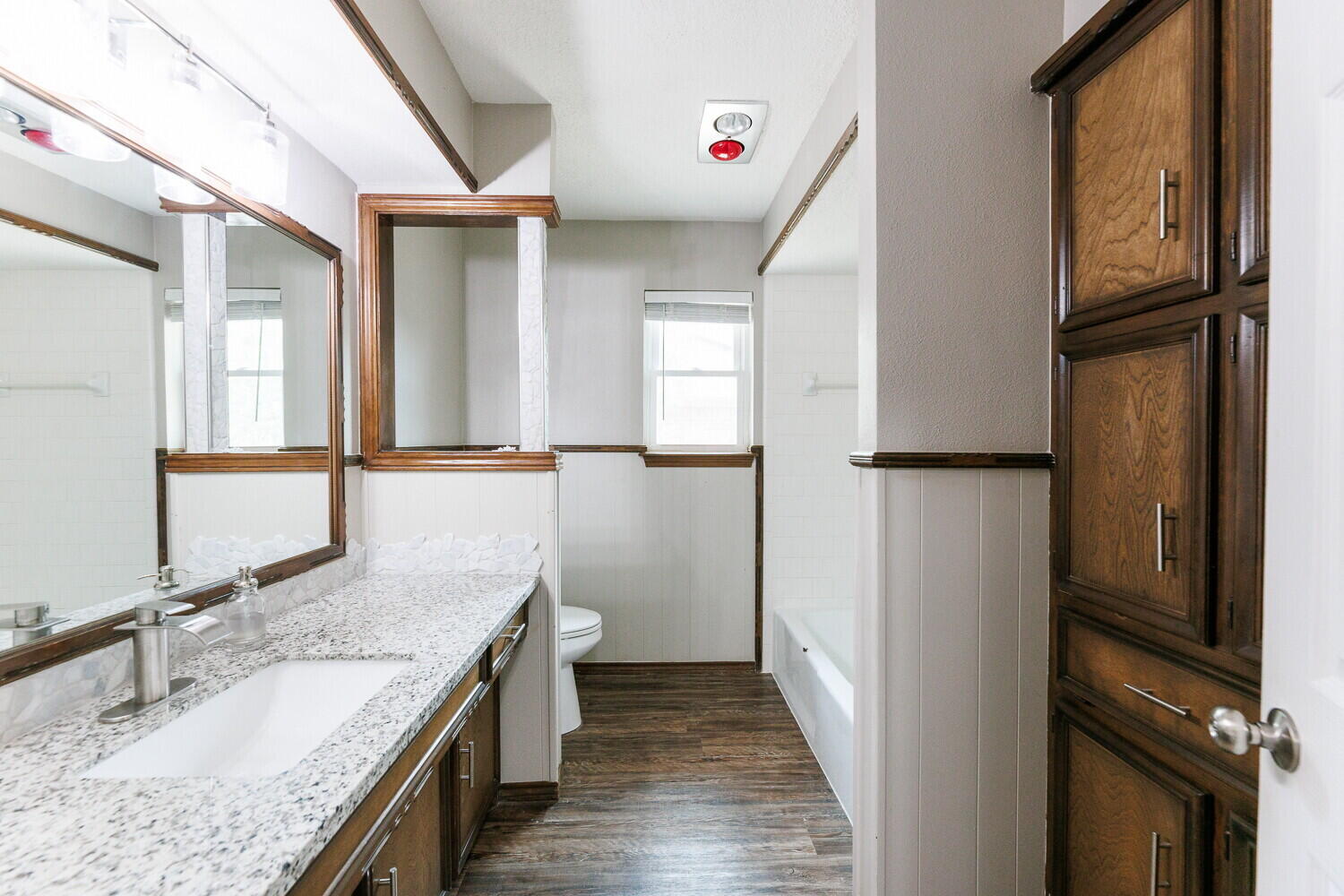 5703 80th Street Lubbock, TX 79424 - Photo 39 of 52 a bathroom with a granite countertop sink and a mirror