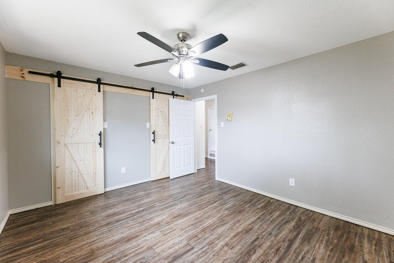 5703 80th Street Lubbock, TX 79424 - Photo 42 of 52 a view of a big room with wooden floor closet and windows