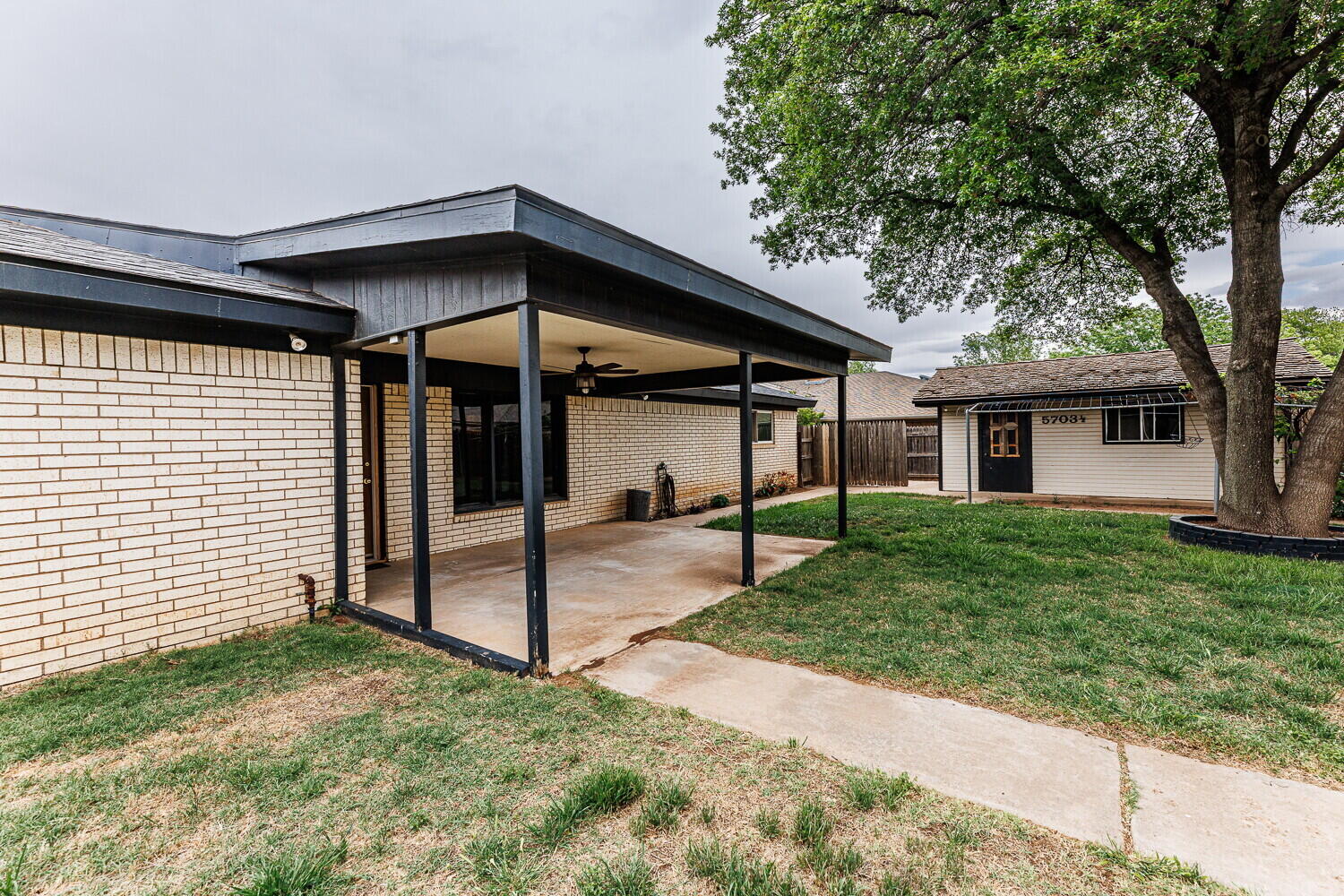 5703 80th Street Lubbock, TX 79424 - Photo 45 of 52 a view of a house with a yard and large tree