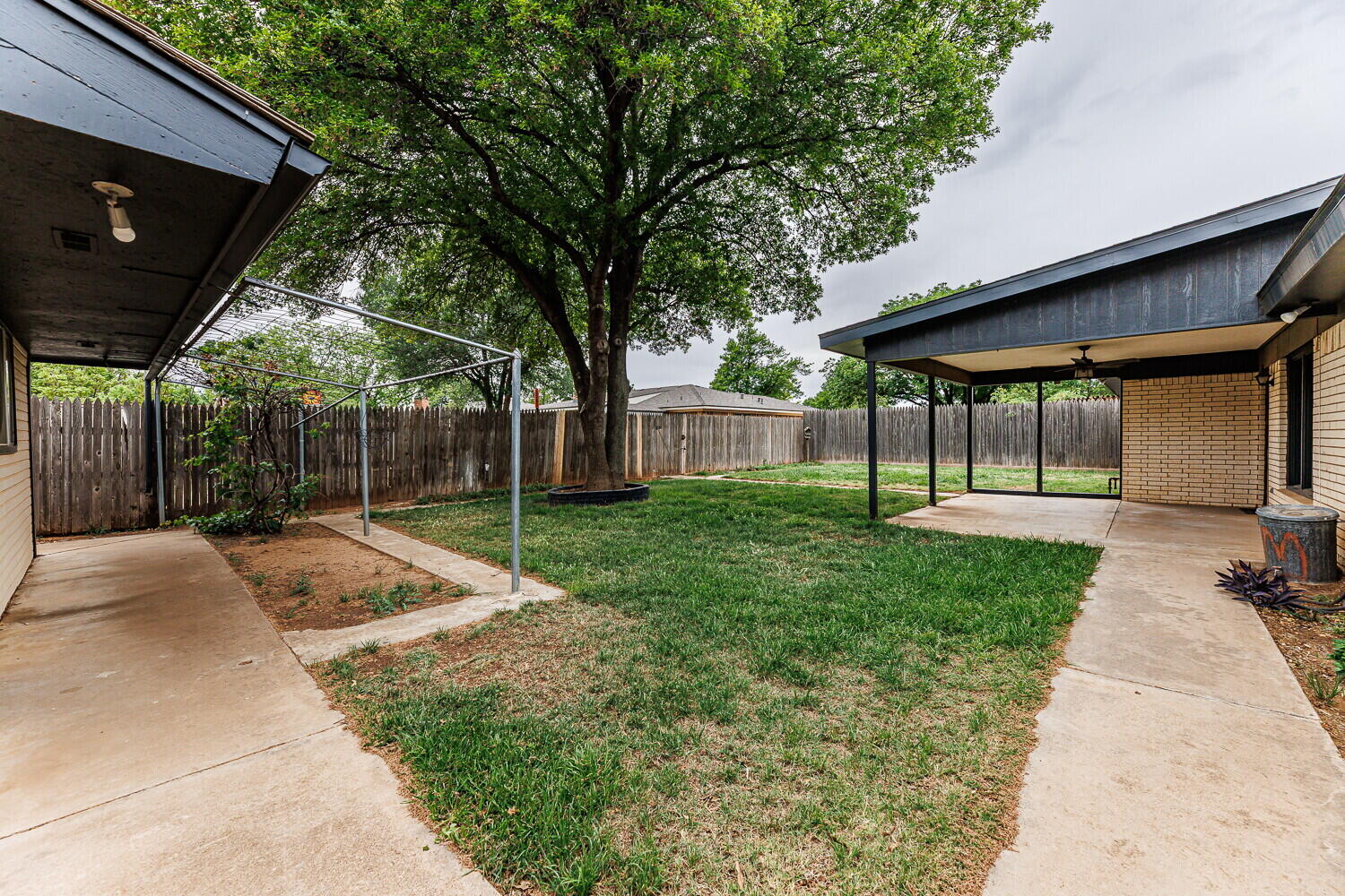 5703 80th Street Lubbock, TX 79424 - Photo 46 of 52 a view of a house with backyard and a tree