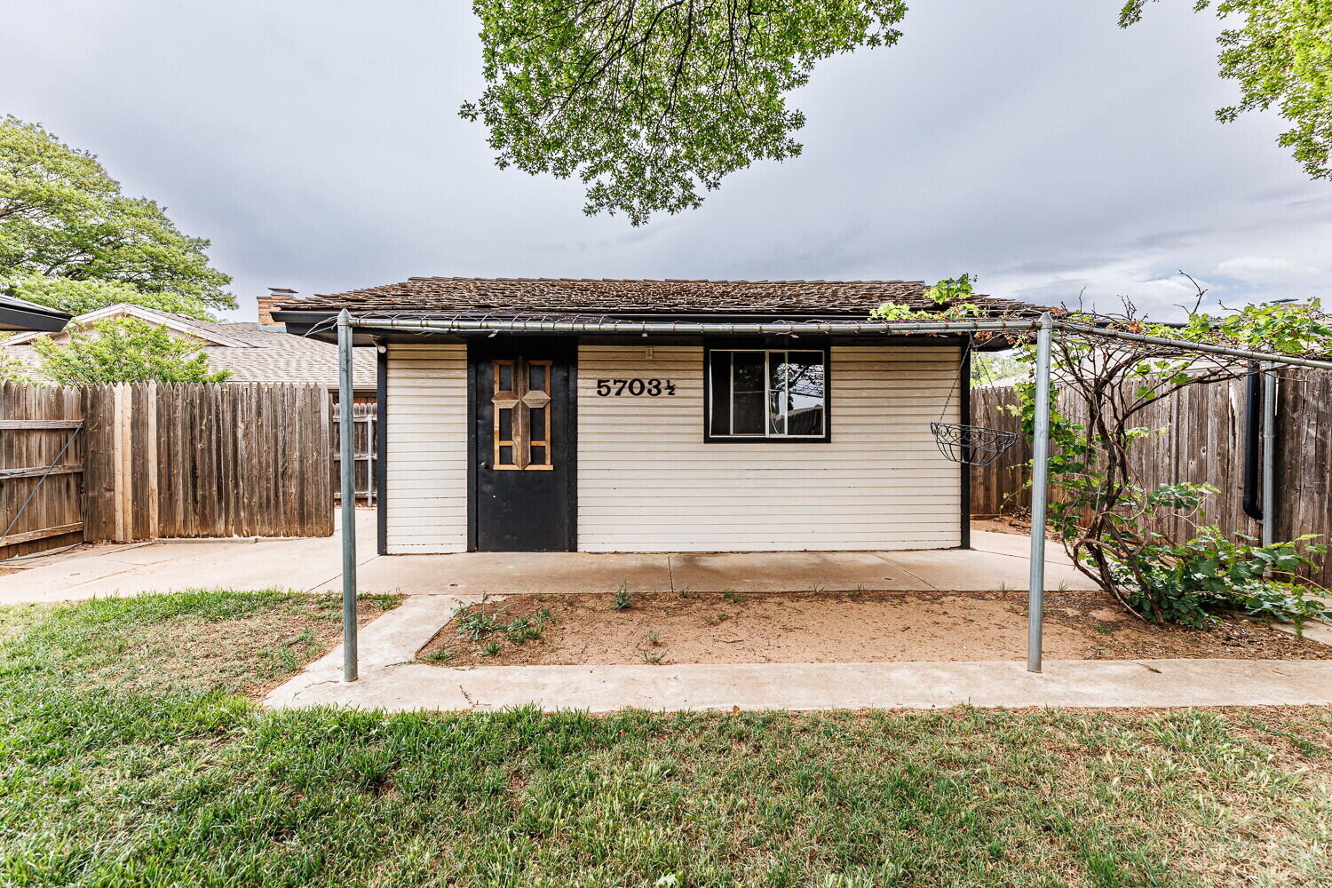 5703 80th Street Lubbock, TX 79424 - Photo 49 of 52 a front view of a house with a yard