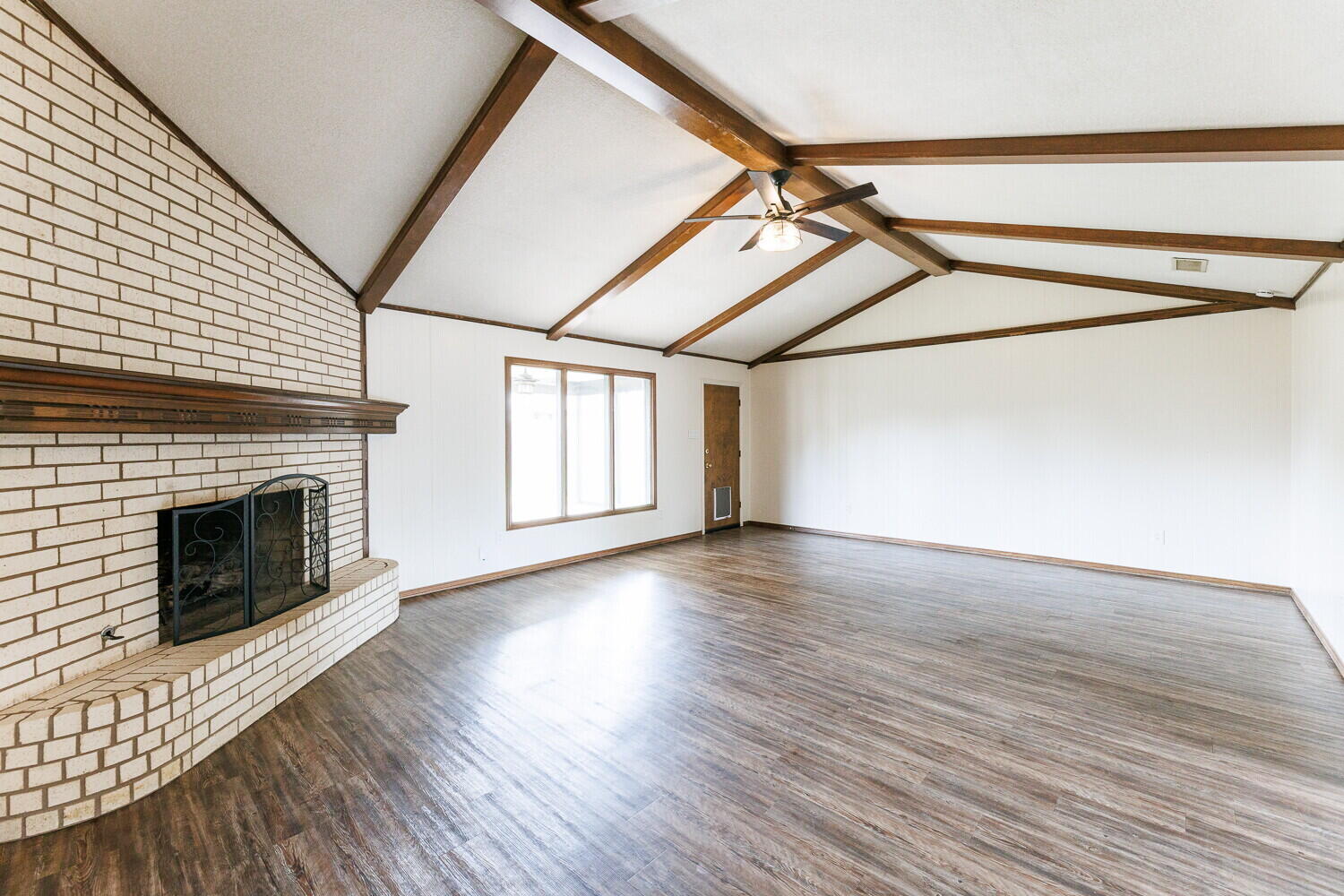 5703 80th Street Lubbock, TX 79424 - Photo 8 of 52 a view of empty room with wooden floor and fireplace