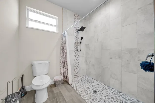 a bathroom with a toilet and a shower