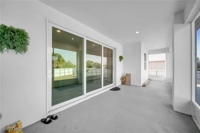 an empty room with windows and entrance