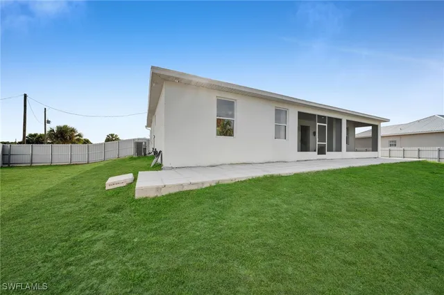 a view of a house with a backyard
