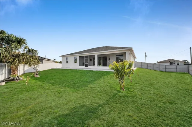 a view of house with a backyard