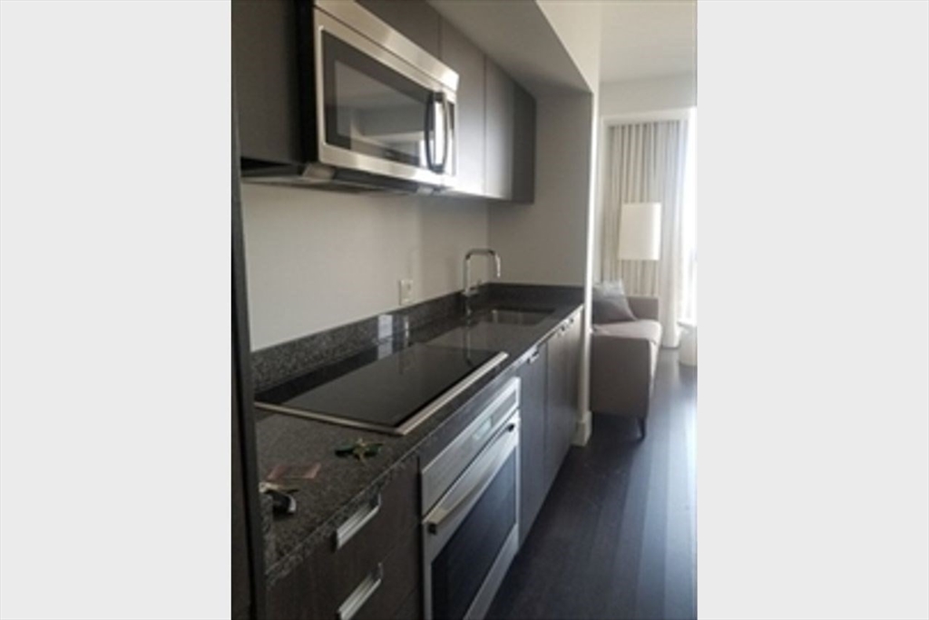 110 Stuart Street, Unit 19D Boston, MA 02116 - Photo 17 of 32 a kitchen with a sink and a microwave