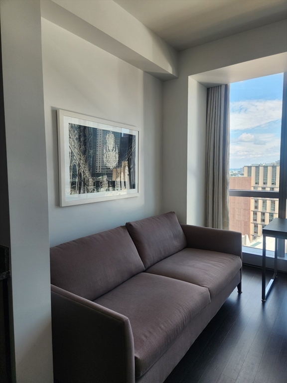 110 Stuart Street, Unit 19D Boston, MA 02116 - Photo 26 of 32 a living room with furniture and a window