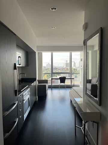 a large kitchen with a large window and stainless steel appliances