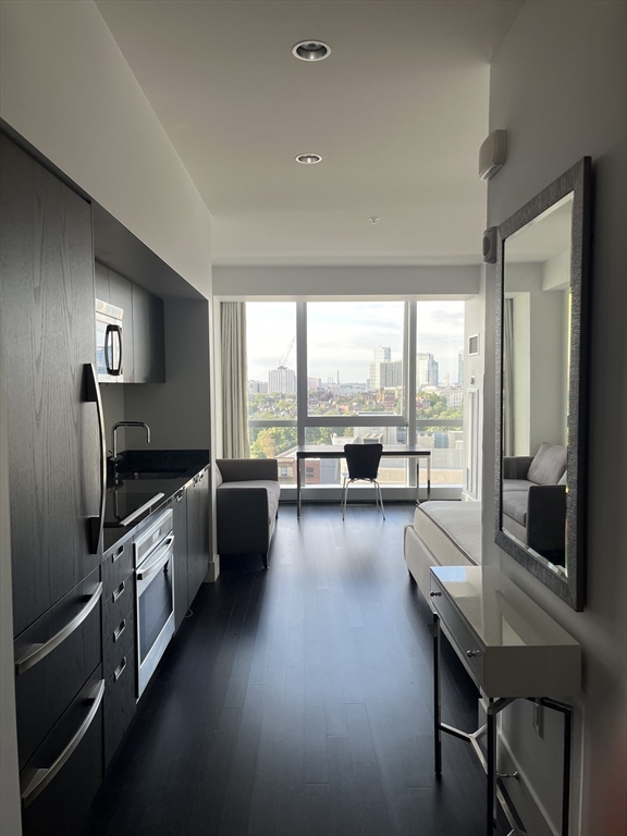 110 Stuart Street, Unit 19D Boston, MA 02116 - Photo 5 of 32 a large kitchen with a large window and stainless steel appliances