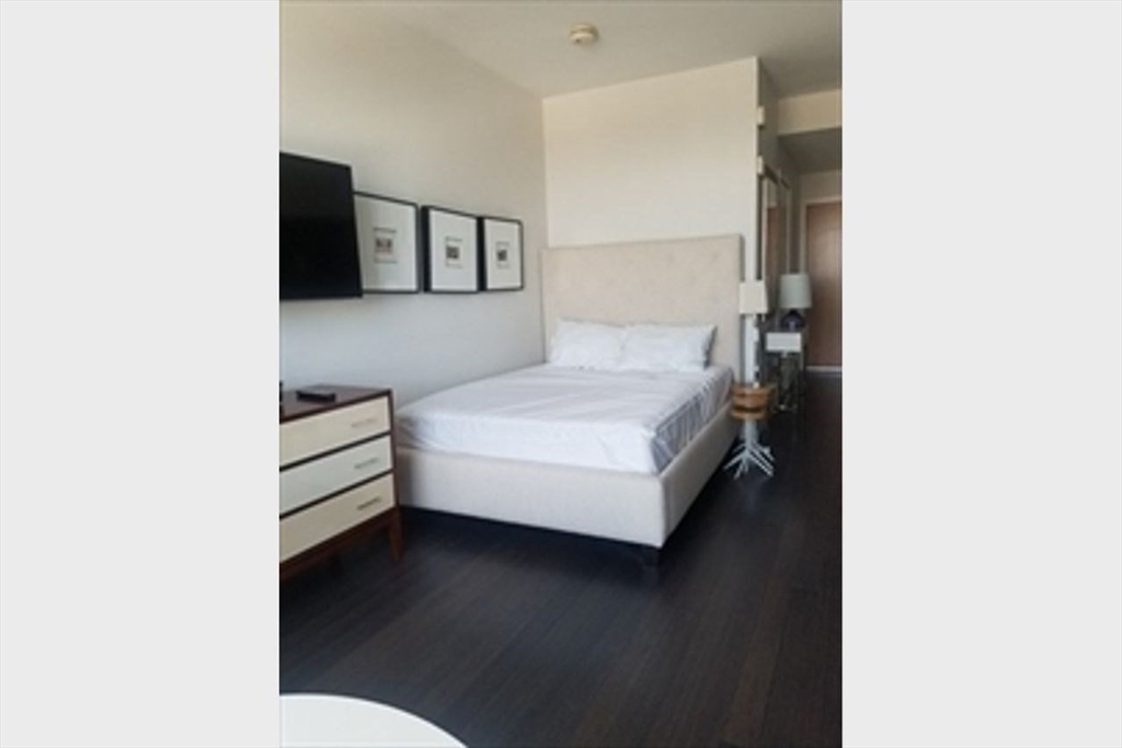 110 Stuart Street, Unit 19D Boston, MA 02116 - Photo 8 of 32 a living room with furniture and wooden floor