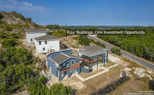 an aerial view of a house with a ocean view