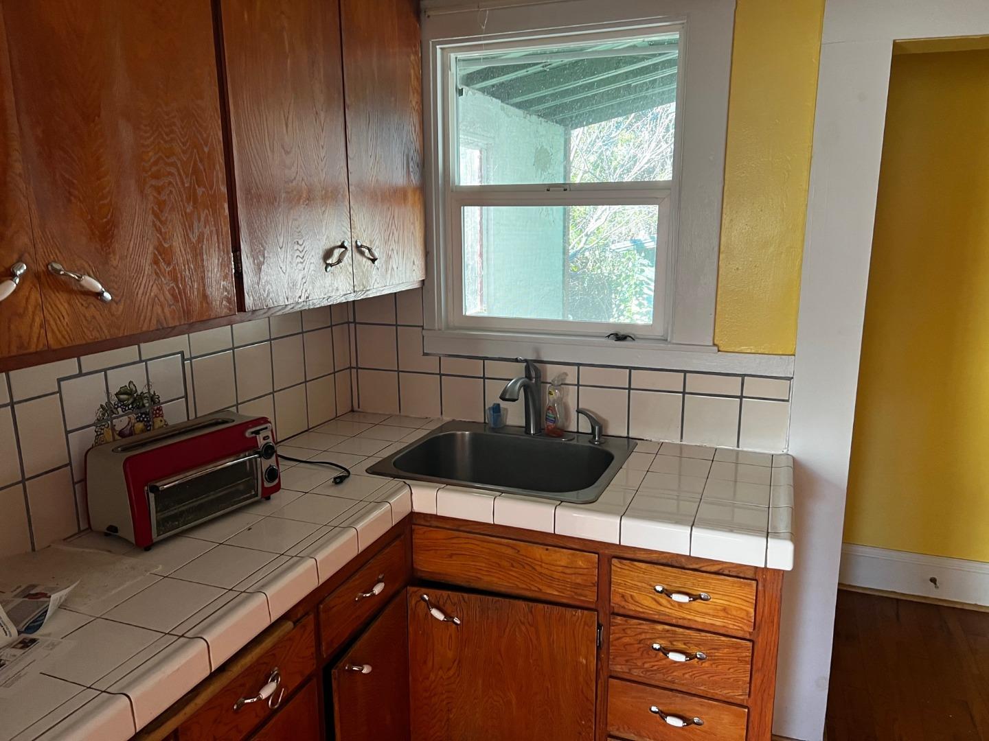917 Channing Way Berkeley, CA 94710 - Photo 12 of 15 a kitchen with a sink a stove and cabinets