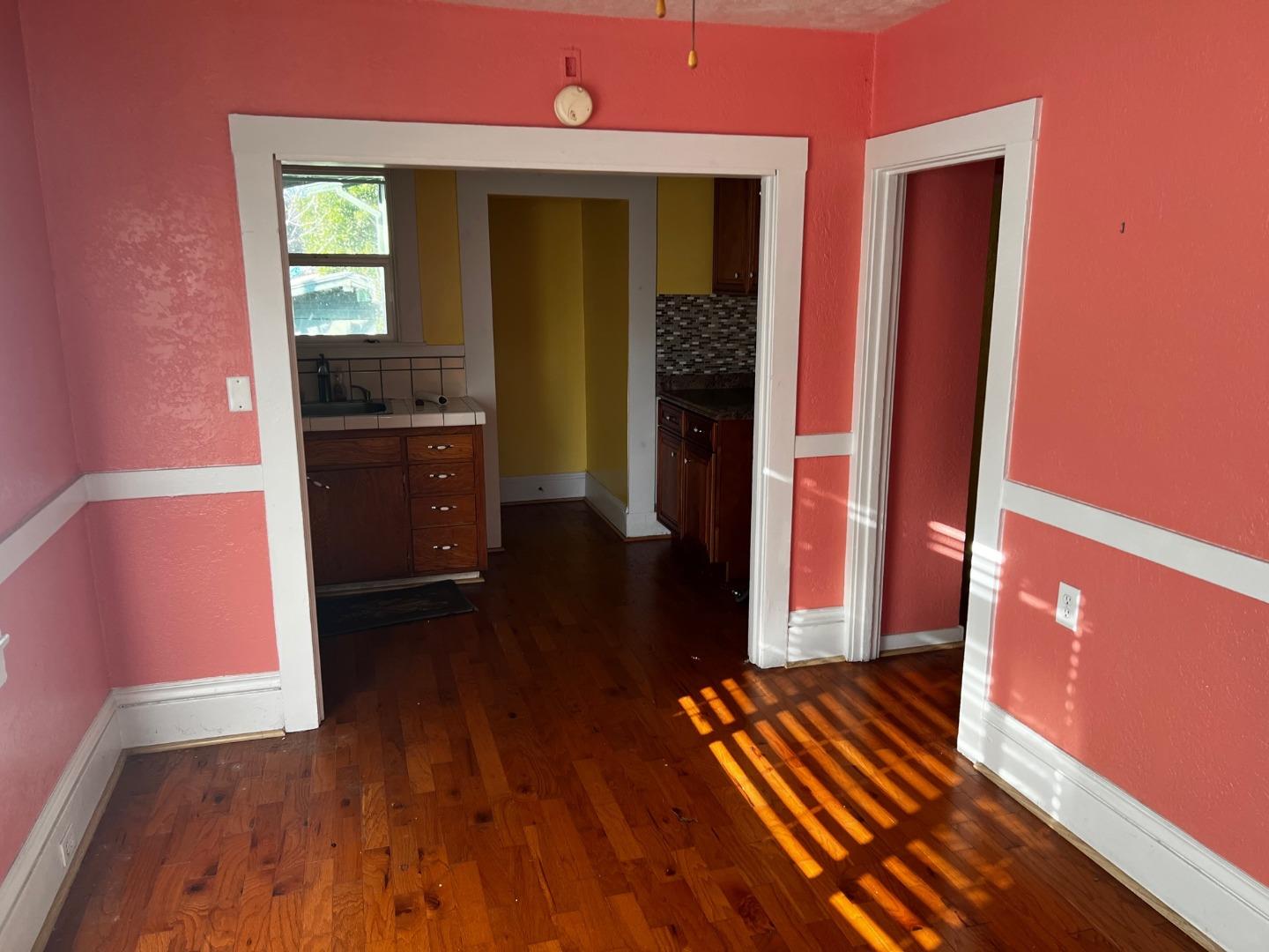917 Channing Way Berkeley, CA 94710 - Photo 5 of 15 a view of empty room with wooden floor and fan