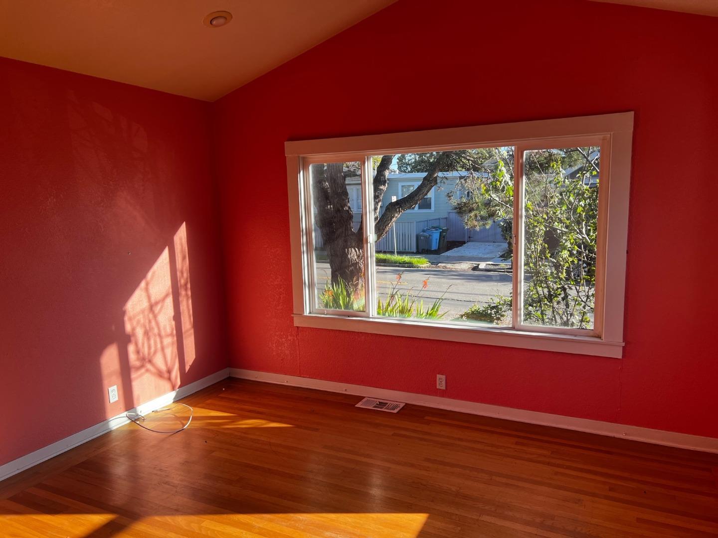 917 Channing Way Berkeley, CA 94710 - Photo 9 of 15 an empty room with wooden floor and a window