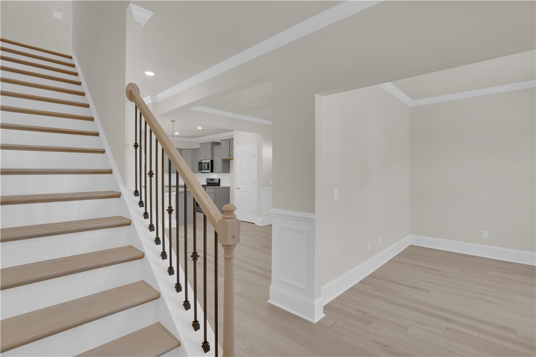 202 Bellflower Lane Pendleton, SC 29670 - Photo 2 of 38 This interior offers a clean aesthetic with a beautiful staircase and crown molding.