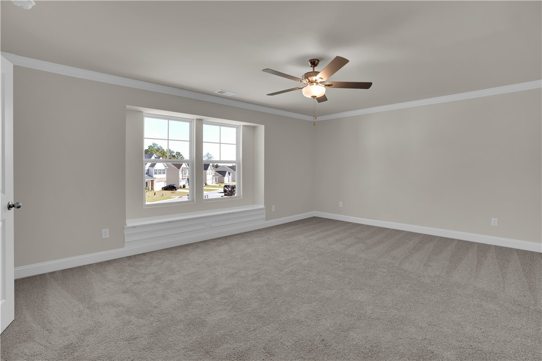 202 Bellflower Lane Pendleton, SC 29670 - Photo 21 of 38 This spacious bedroom offers ample natural light and comfortable carpet flooring, ready for your personal touch.