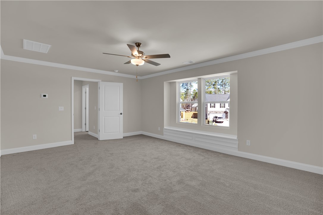 202 Bellflower Lane Pendleton, SC 29670 - Photo 22 of 38 This airy room features ample natural light and plush carpeting, creating a comfortable living space.