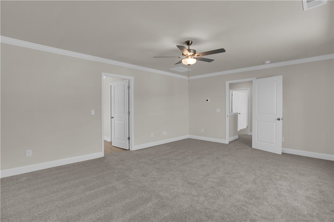 202 Bellflower Lane Pendleton, SC 29670 - Photo 23 of 38 This expansive room offers a versatile layout, featuring plush carpeting and bright, inviting doorways.