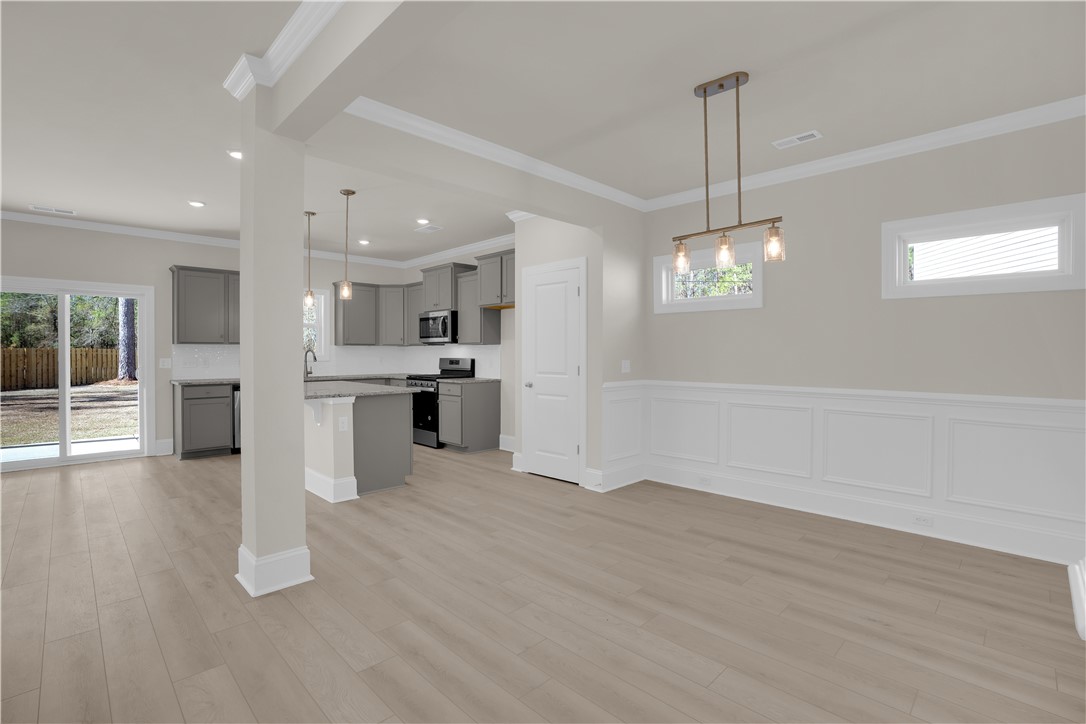 202 Bellflower Lane Pendleton, SC 29670 - Photo 7 of 38 This open concept living area features sleek flooring, a modern kitchen, and convenient outdoor access.