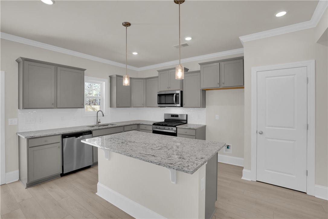 202 Bellflower Lane Pendleton, SC 29670 - Photo 10 of 38 This kitchen features sleek countertops, modern appliances, and a central island for culinary endeavors.