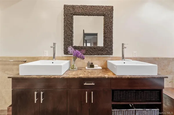 a bathroom with a granite countertop sink and a mirror