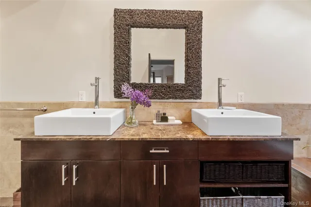 a bathroom with a granite countertop sink and a mirror