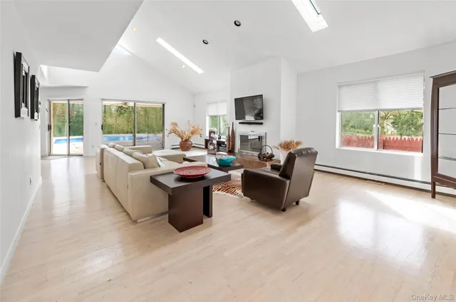 a living room with furniture a large window and a flat screen tv