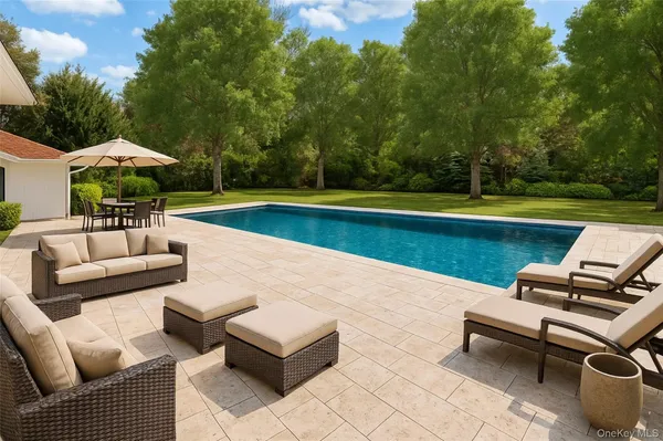 an outdoor sitting area with a couch and garden view
