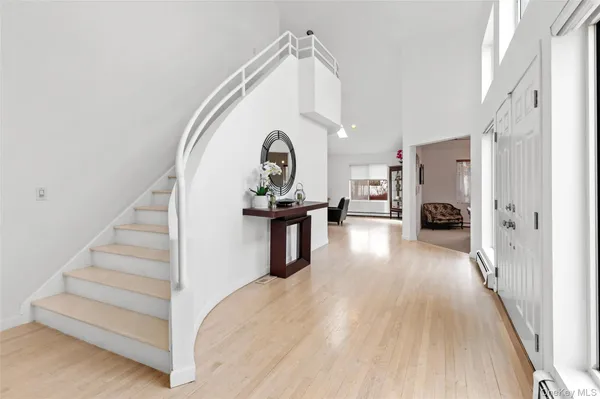 a view of a living room and entryway with wooden floor