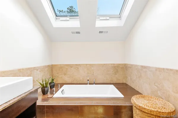 a bathroom with a bathtub and a sink