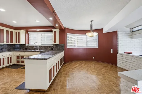 a view of kitchen with furniture and refrigerator