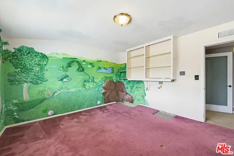 a view of a livingroom with an empty space and a window