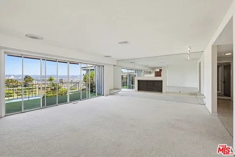 a living room with furniture kitchen view and a table