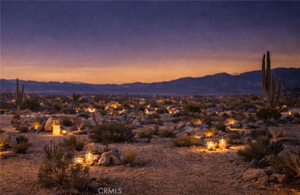 543050 Red Ryder Road Pioneertown, CA 92268 - Photo 8 of 20 a view of a lush green field with mountains in the background