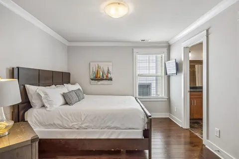 a bedroom with a large bed and a window