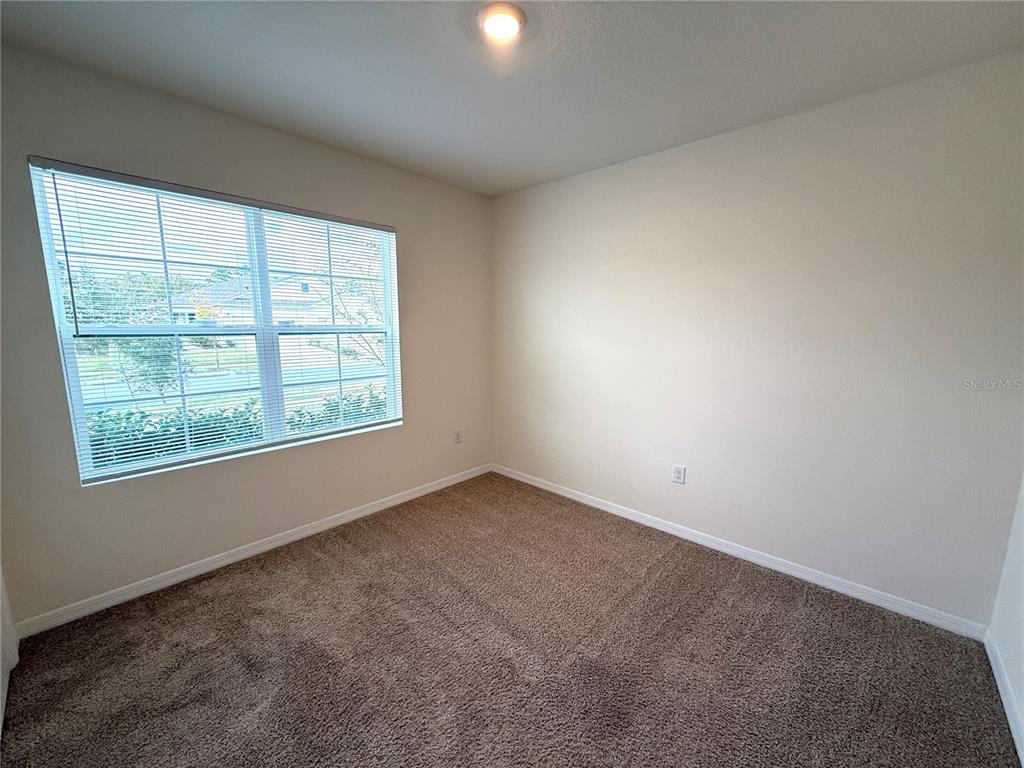 2877 Sunridge Loop St. Cloud, FL 34771 - Photo 13 of 19 an empty room with a window