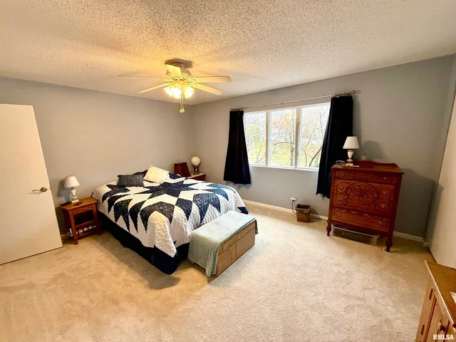 a spacious bedroom with a bed and window