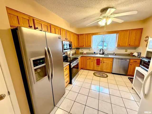 a kitchen with stainless steel appliances a refrigerator sink and cabinets