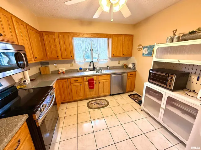 a kitchen with stainless steel appliances a stove sink and cabinets