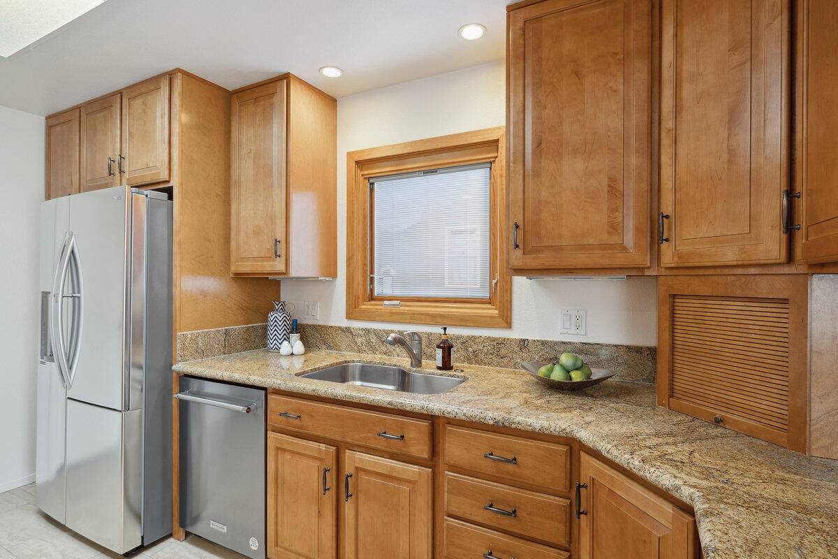 7165 Del Norte Drive Goleta, CA 93117 - Photo 7 of 30 a kitchen with stainless steel appliances granite countertop a refrigerator and a sink