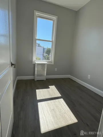 an entryway of a house with wooden floor