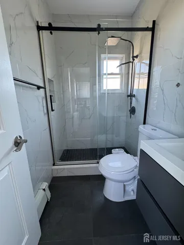 a bathroom with a toilet and a shower