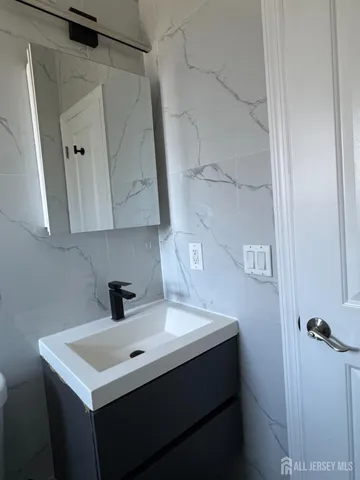 a bathroom with a sink and mirror