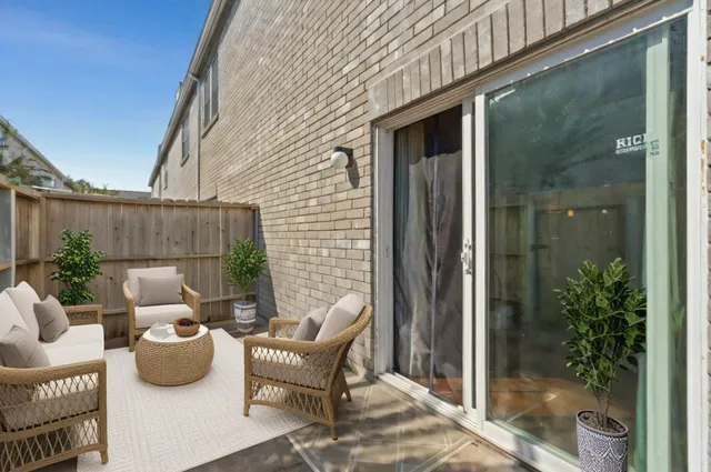 a view of backyard from deck with patio