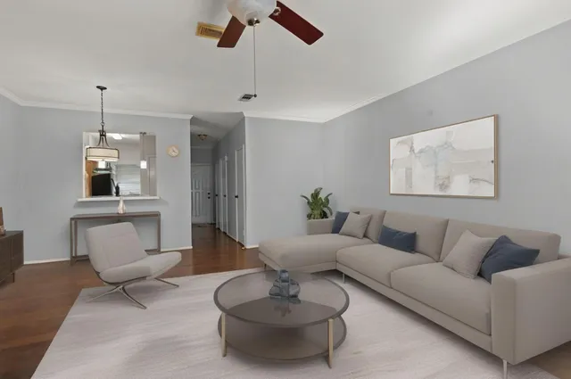 a living room with furniture and a wooden floor