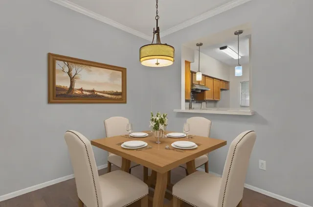a view of a dining room with a table and chairs