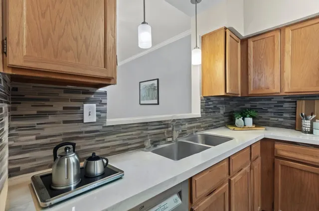 a kitchen with a sink cabinets and window