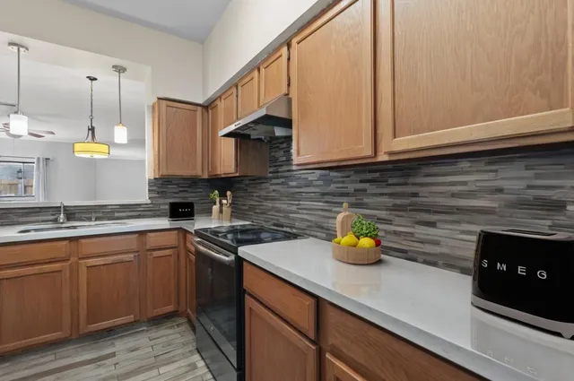 a kitchen with a sink a counter space and cabinets