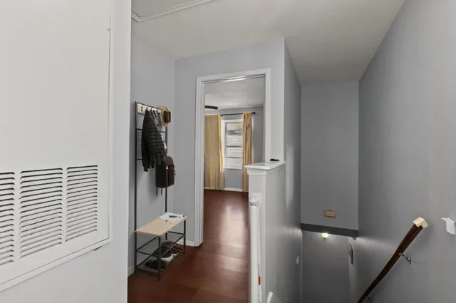 a view of a hallway with a couch and a window